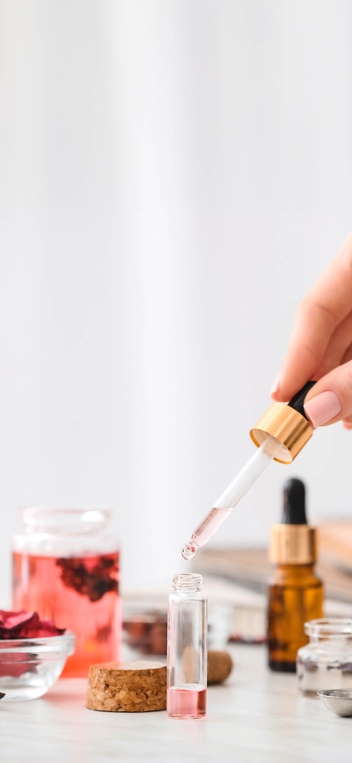 Woman preparing perfume on table